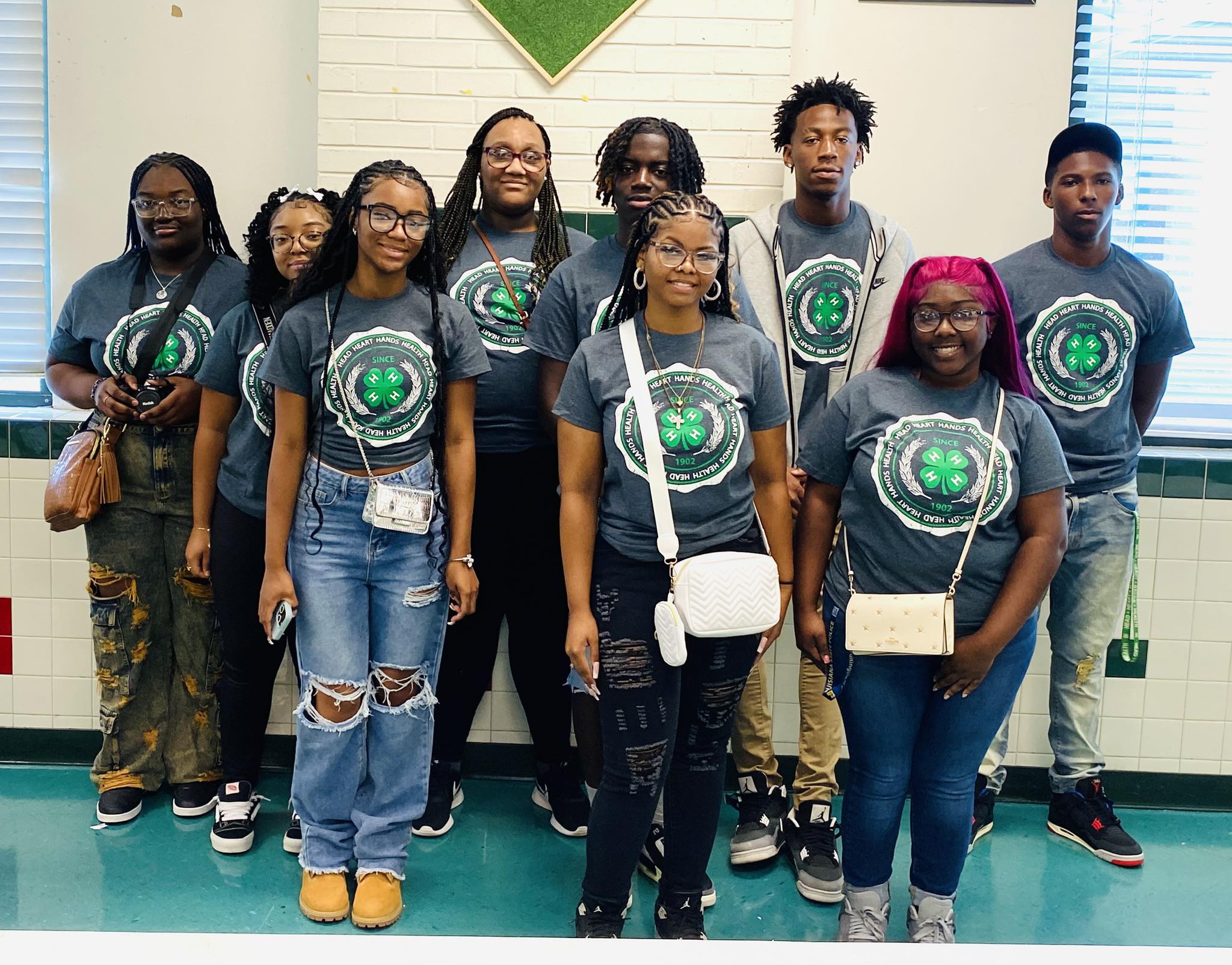 A group of teenagers posing for a picture.